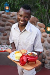 Butler with food at grace of africa